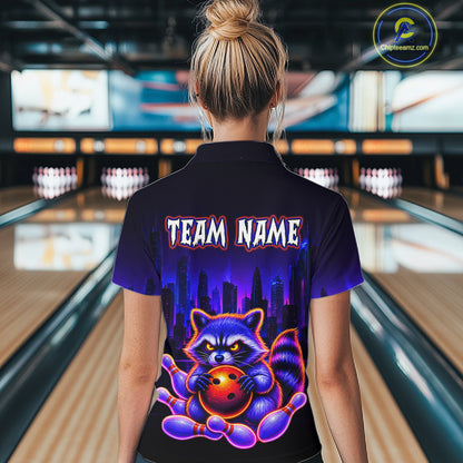 Women wearing bowling quarter zip shirt featuring a raccoon holding a bowling ball framed by pins with purple city skyline background.