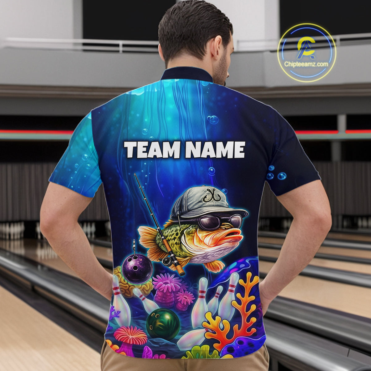 Man wearing an underwater-themed bowling quarter zip featuring a fish mascot wearing sunglasses and a cap, colorful coral reefs, bowling pins, bowling balls, and custom team name text.