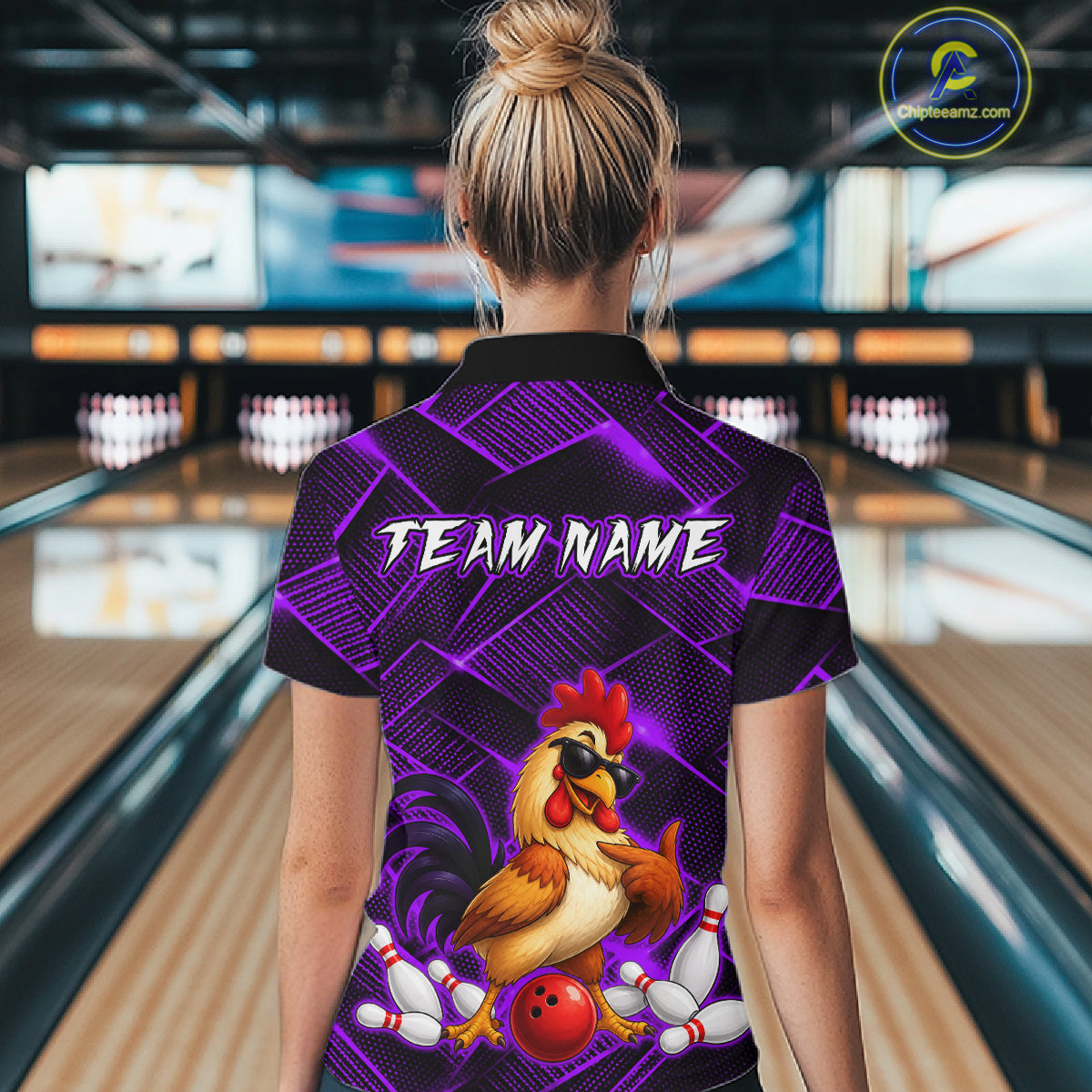 Woman wearing a purple and black bowling polo shirt featuring a cool rooster mascot wearing sunglasses, a red bowling ball, bowling pins, and custom team name text.