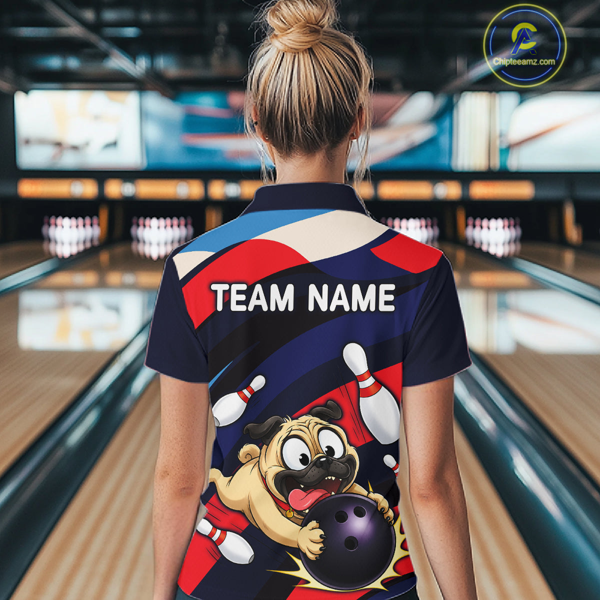 Person wearing a navy, red, and white bowling quarter zip featuring a cartoon pug holding a purple bowling ball, pins, and custom team text.