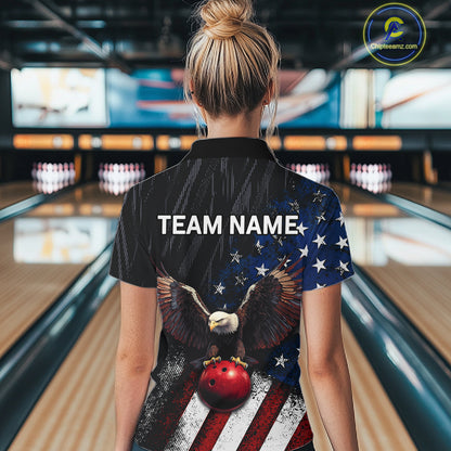A woman viewed from behind wearing a custom bowling shirt with a patriotic American flag design featuring a bald eagle and bowling ball graphic, with 'TEAM NAME' printed on the back. The background shows a blurred bowling alley.