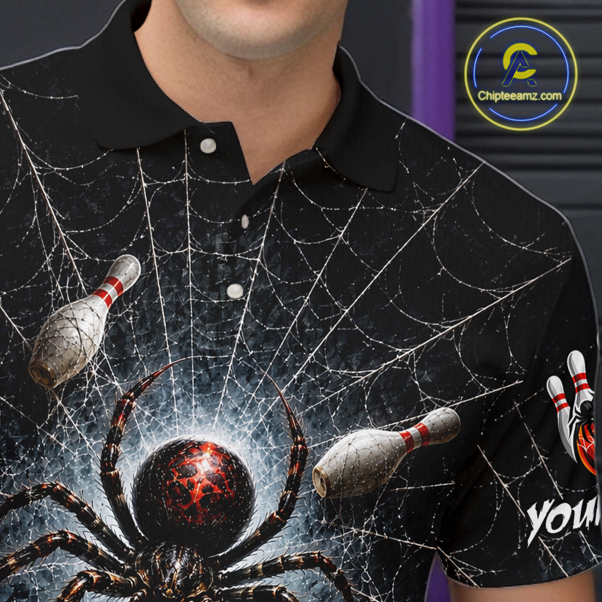 A close-up of a person wearing a black short-sleeve polo shirt with a detailed graphic print of a large spider, cobweb patterns, bowling pins, and a red glowing orb. The brand logo 'ChipteeAmz'.