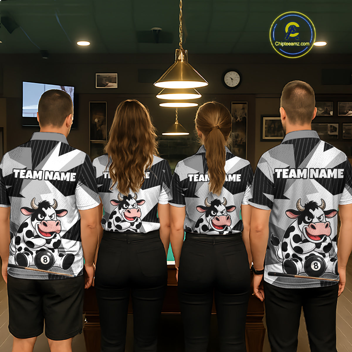 Four people wearing matching shirts with cow graphics and 'Team Name' text in a room.