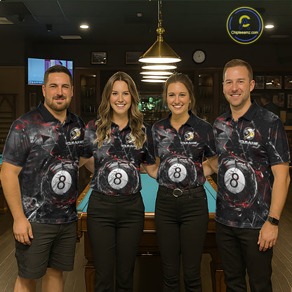 Four people standing with their fronts facing the camera in a billiards hall, wearing matching black polo shirts with shattered-glass graphics, “YOUR NAME” text, and large black 8-ball designs on the front.