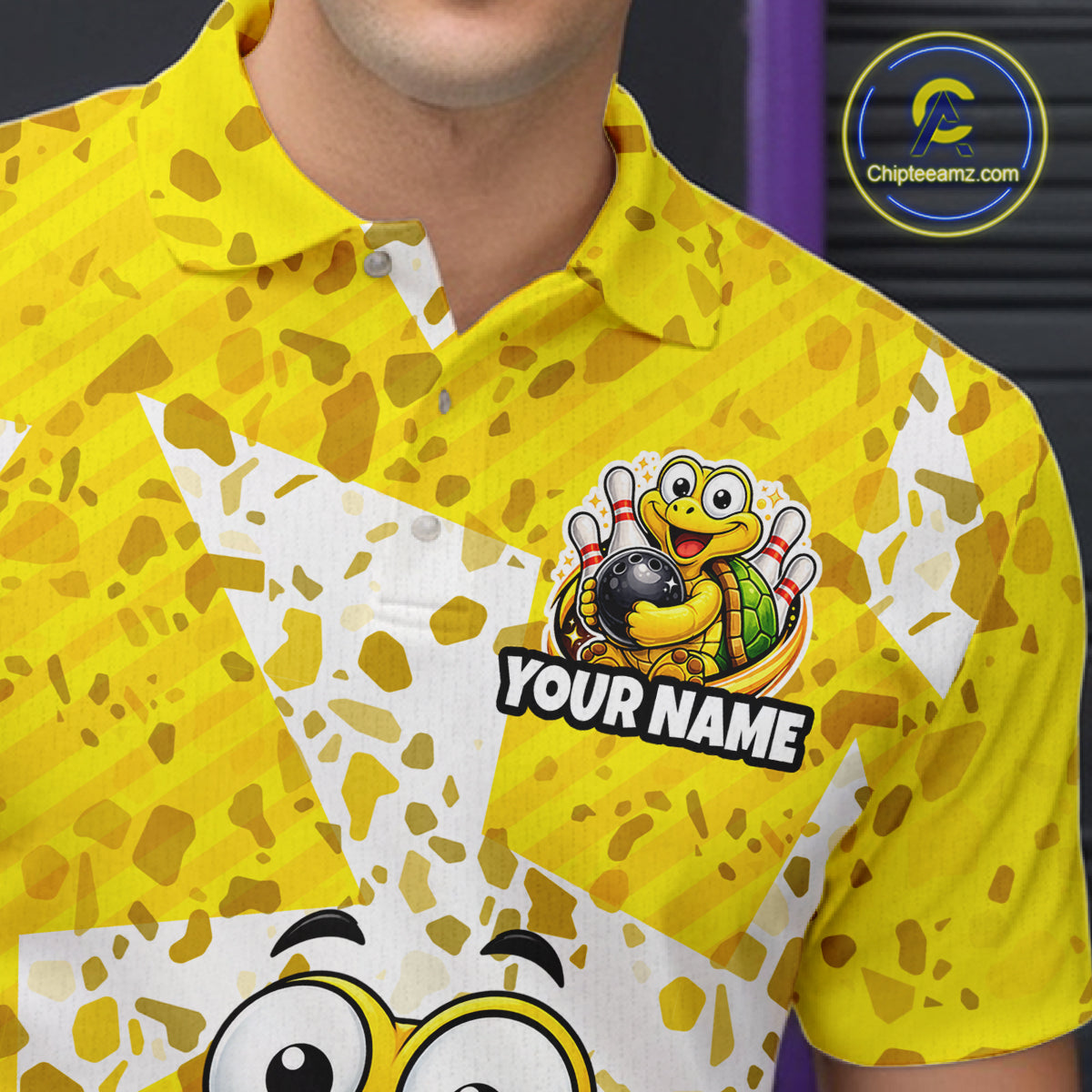 Detailed view of a yellow collared bowling jersey with white geometric accents, playful turtle bowling artwork, and personalized name text on the chest.