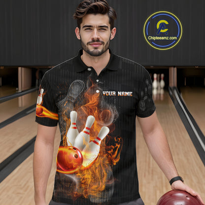 A man wearing a black short-sleeve polo shirt with a custom bowling-themed flame graphic on the front, standing in a bowling alley. The shirt features a graphic of bowling pins, a red bowling ball, and orange flames, with 'YOUR NAME' printed on the chest.