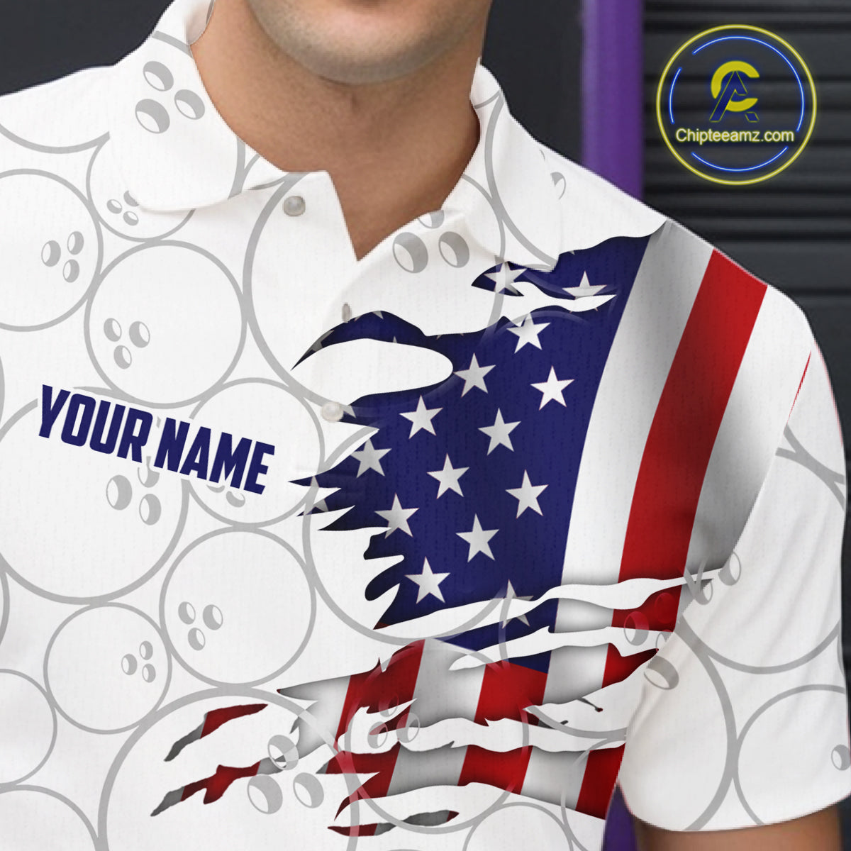 A close-up of a person wearing a white short-sleeve polo shirt with a patriotic graphic. The design features a torn-paper effect revealing an American flag pattern with blue, red, and white stripes and white stars.