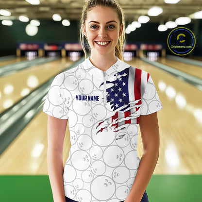 A woman stands in a bowling alley wearing a white short-sleeve polo shirt with a printed bowling-ball pattern and a torn American flag graphic on the right side. The shirt has 'YOUR NAME' printed on the chest.