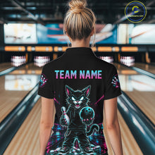 Load image into Gallery viewer, A woman viewed from behind wearing a black short-sleeve polo shirt with a large colorful graphic of a cartoon cat holding a bowling ball on the back, with 'TEAM NAME' printed above it. The background shows blurred bowling alley lanes.