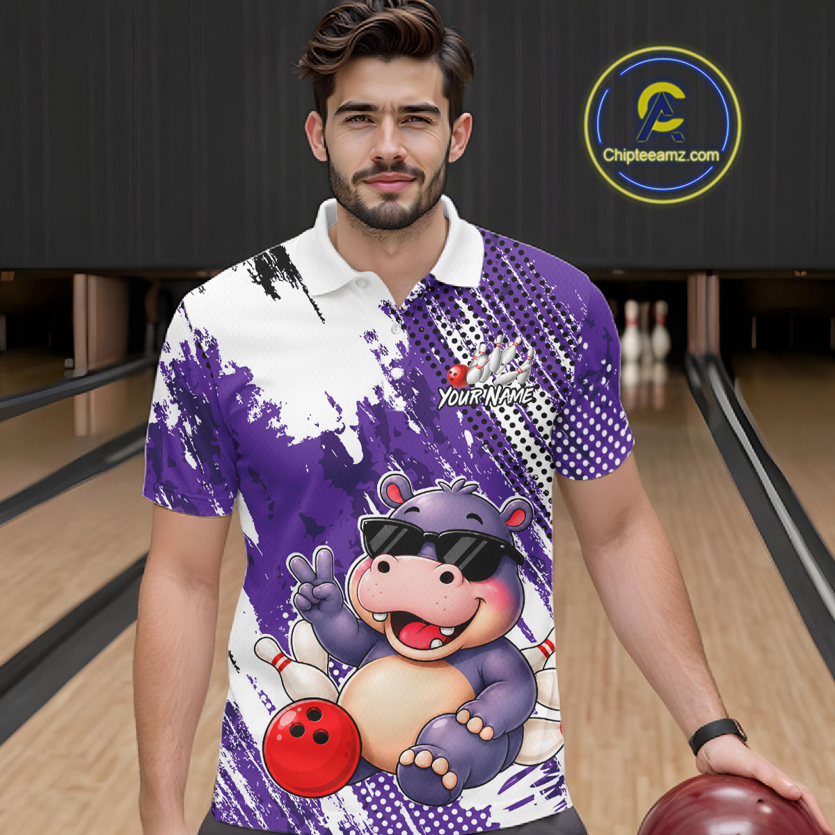 Man wearing a bowling polo shirt featuring smiling hippo mascot in sunglasses, bowling pins, and a red bowling ball