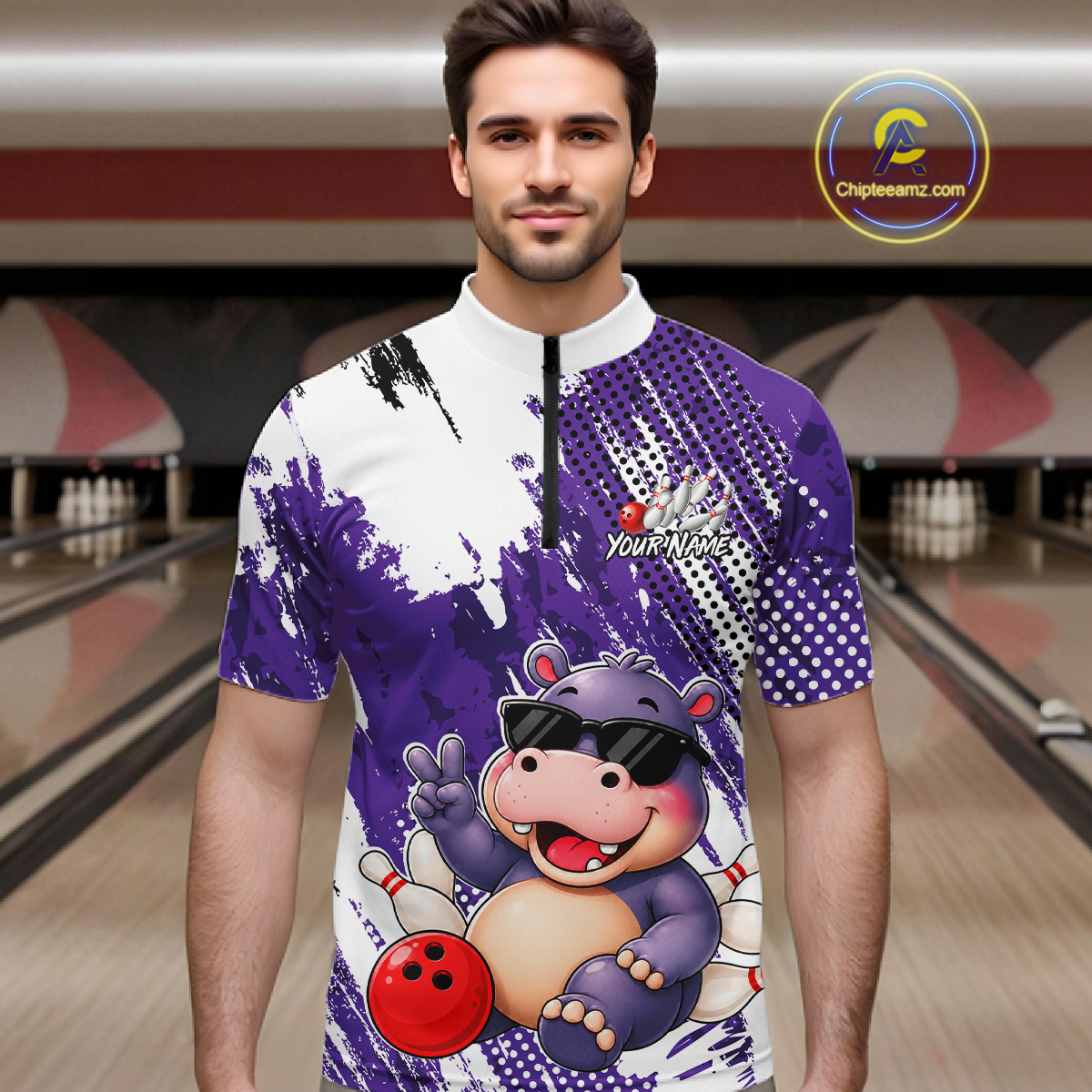 Man wearing a bowling quarter zip shirt featuring smiling hippo mascot in sunglasses, bowling pins, and a red bowling ball