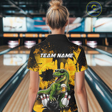 Load image into Gallery viewer, Women wearing bowling polo shirt featuring a dinosaur holding beer with bowling pins and ball artwork on black yellow background.