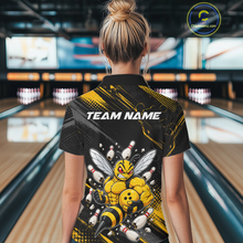 Load image into Gallery viewer, Women wearing bowling quarter zip shirt featuring a muscular bee holding a bowling ball surrounded by pins on black yellow background.