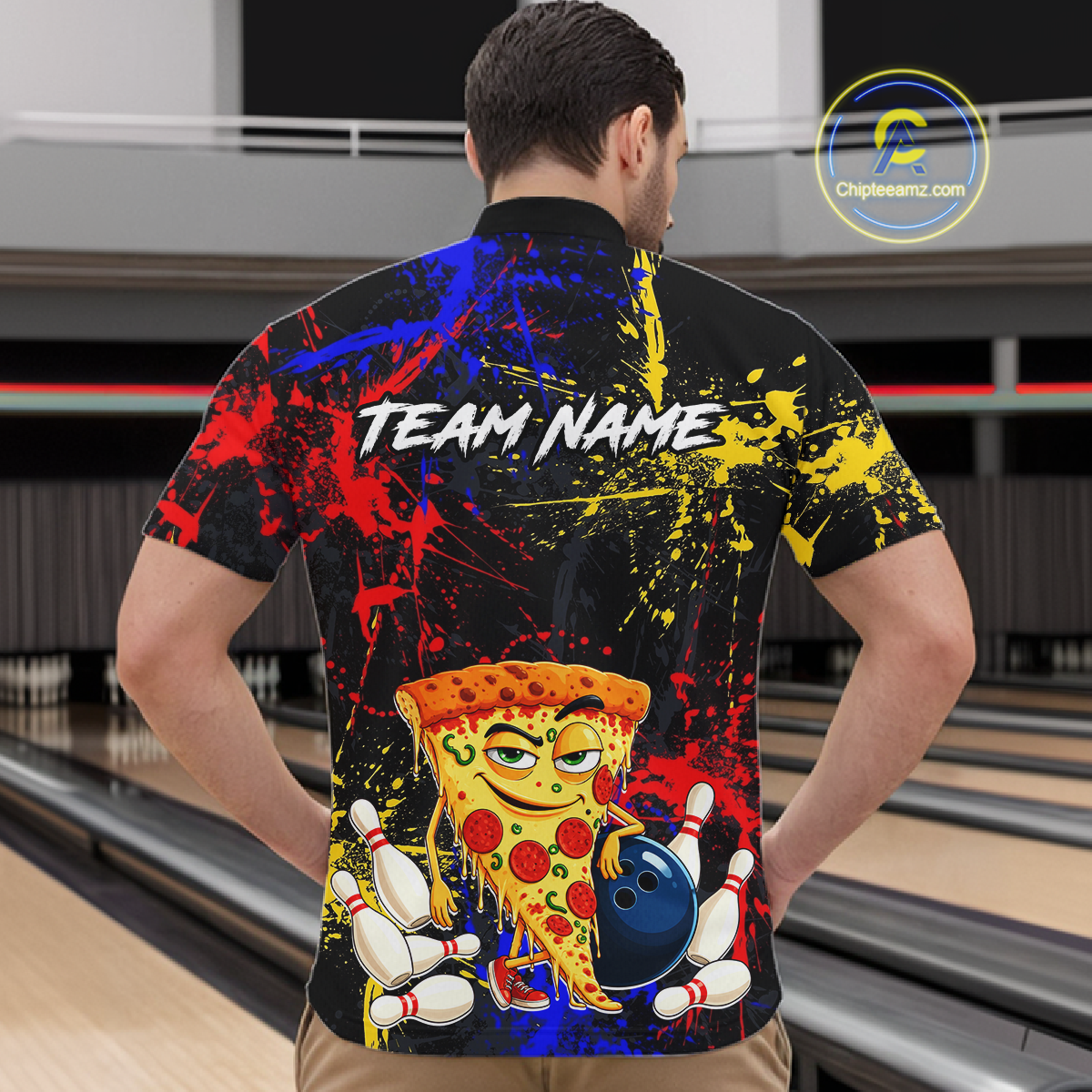 Man wearing a black bowling quarter zip featuring colorful red, yellow, and blue paint splatter graphics, a cartoon pizza slice mascot, bowling pins, and custom team name text.