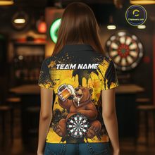 Load image into Gallery viewer, Person wearing a black and yellow darts polo featuring a bear drinking beer, dartboard graphics, and custom team and player name text.