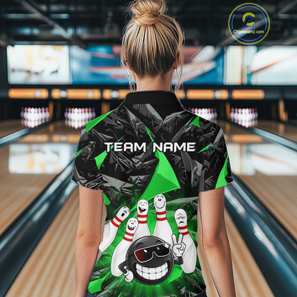 A woman viewed from behind wearing a custom bowling-themed short-sleeve polo shirt. The shirt features a black and green geometric pattern with a cartoon bowling ball and pins graphic, and the text 'TEAM NAME' printed on the back.