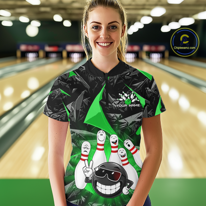 A woman stands in a bowling alley wearing a custom short-sleeve bowling shirt with a black and green geometric pattern and a cartoon bowling pin graphic. The shirt has a placeholder name printed on the chest.
