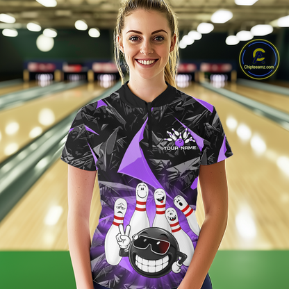 A woman stands in a bowling alley wearing a black and purple bowling-themed short-sleeve polo shirt with a cartoon bowling ball and pins graphic. The background shows blurred bowling lanes, and a circular 'Chilewich.