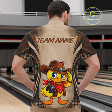 Load image into Gallery viewer, Person wearing a bowling shirt with a duck design and 'Team Name' text in a bowling alley.