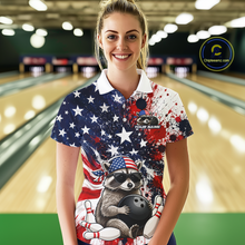 Load image into Gallery viewer, Women’s us flag raccoon bowling polo shirt, front view on female model in bowling lane 