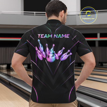 Load image into Gallery viewer, Person wearing a black bowling shirt with colorful design and 'TEAM NAME' text at a bowling alley.