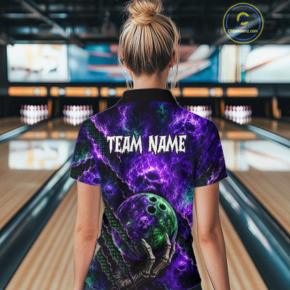 A woman viewed from behind wearing a short-sleeve bowling-themed polo shirt with a purple and black cosmic design, a bowling ball graphic, and the text 'TEAM NAME' on the back. Bowling lanes are visible in the background