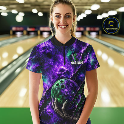 A woman stands in a bowling alley wearing a short-sleeve collared shirt with a purple and green cosmic nebula print, featuring a bowling ball graphic and skeleton hand, with 'YOUR NAME' printed on the chest. 