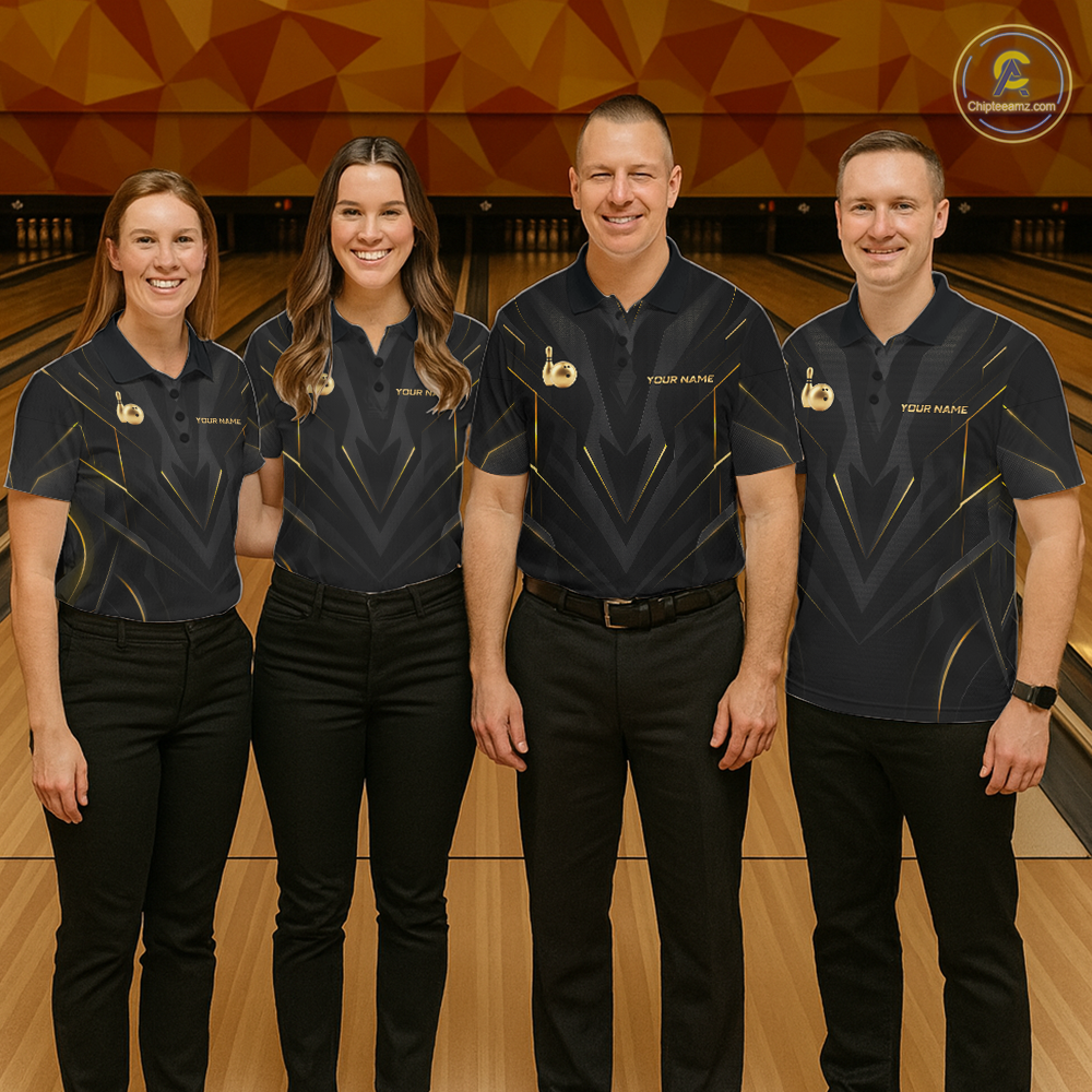 Four people in matching bowling alley uniforms standing on a bowling lane.