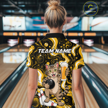 A woman viewed from behind wearing a bowling-themed short-sleeve polo shirt with a cartoon cat holding a beer glass and the text 'TEAM NAME' on the back. The shirt has a black and yellow marbled pattern with a cat graphic.