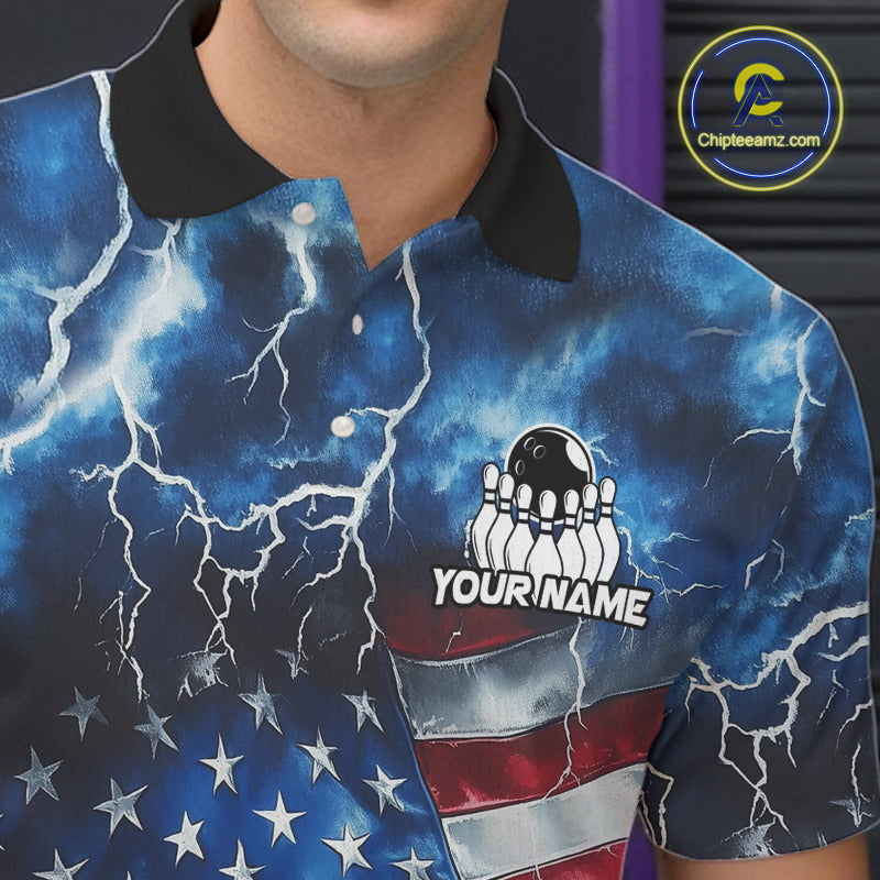 A close-up of a person wearing a short-sleeve polo shirt with a blue lightning-and-flag print, black collar, and a bowling pins graphic with the text 'YOUR NAME'. 