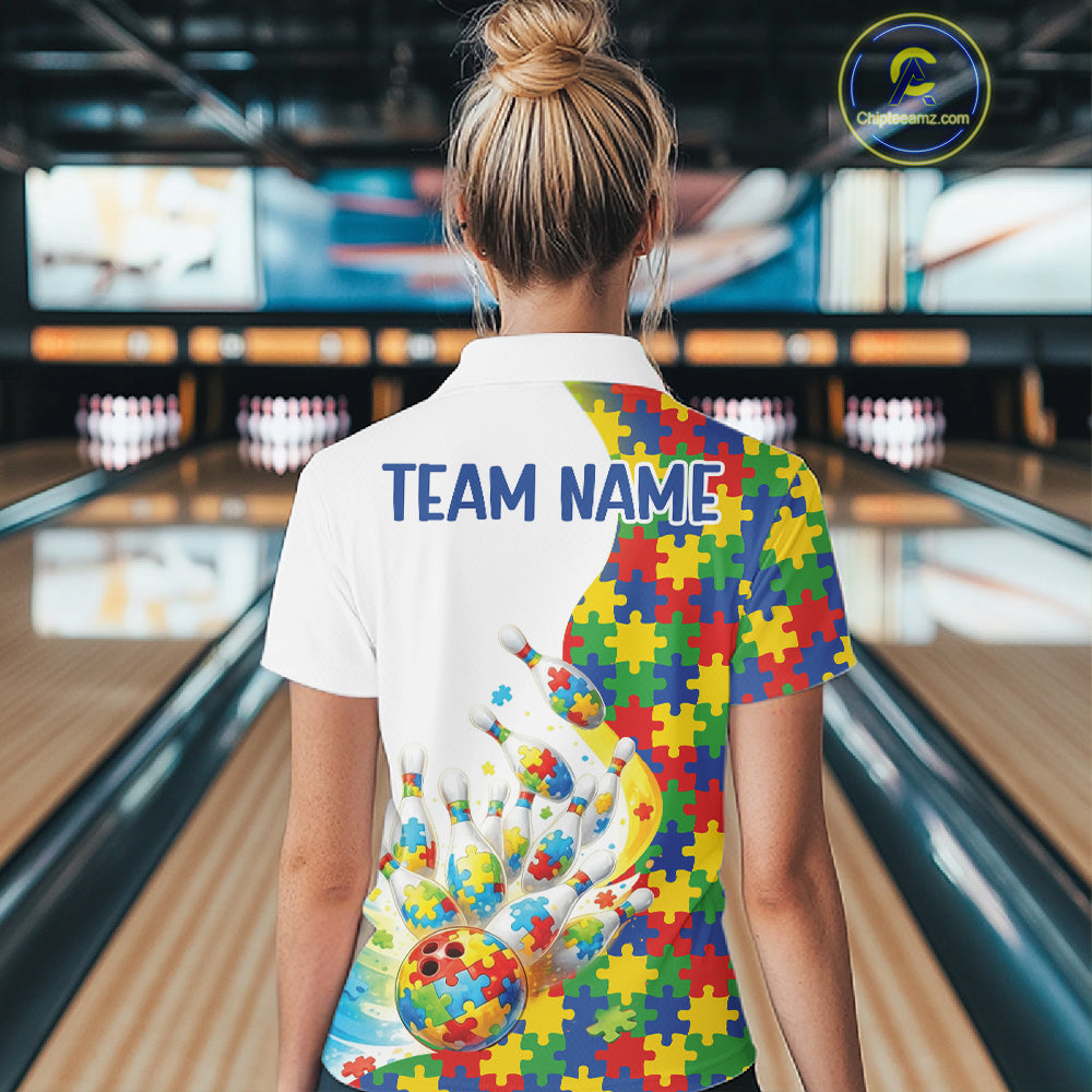 Back view of a female bowler wearing a quarter-zip shirt, autism puzzle design with colorful bowling strike illustration.