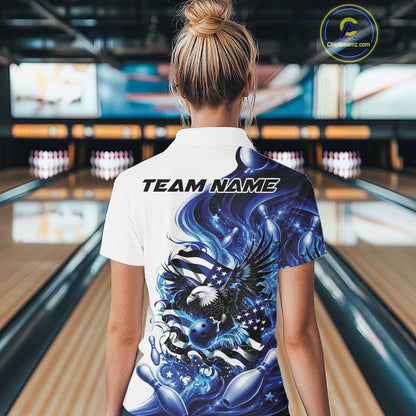 Back view female model in a bowling lane wearing a white and blue quarter zip shirt with eagle artwork and flowing American flag inspired accents.