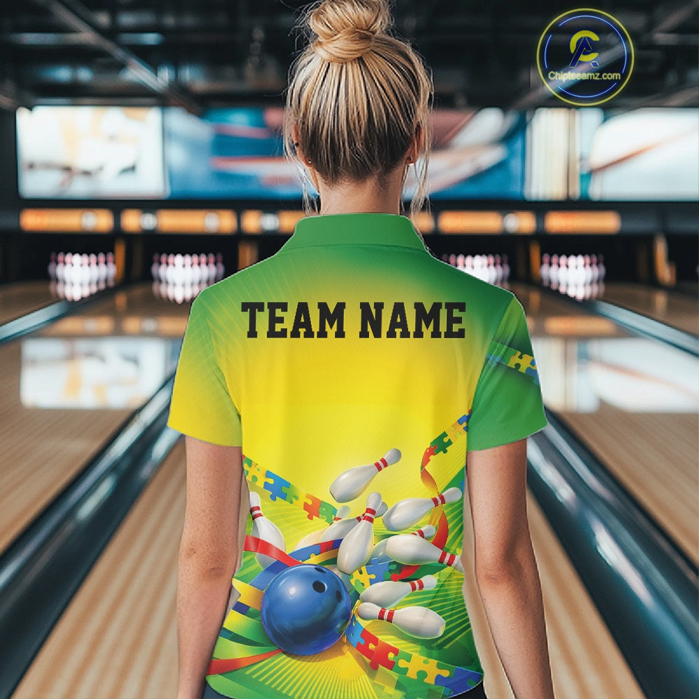 Female model at a bowling lane, back view of green and yellow polo shirt featuring autism puzzle bowling ball and pins graphics