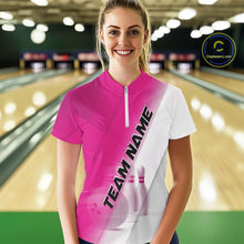 Load image into Gallery viewer, Front view of a female model at a bowling lane wearing a quarter zip shirt with bowling ball and pins in a pink and white diagonal layout.