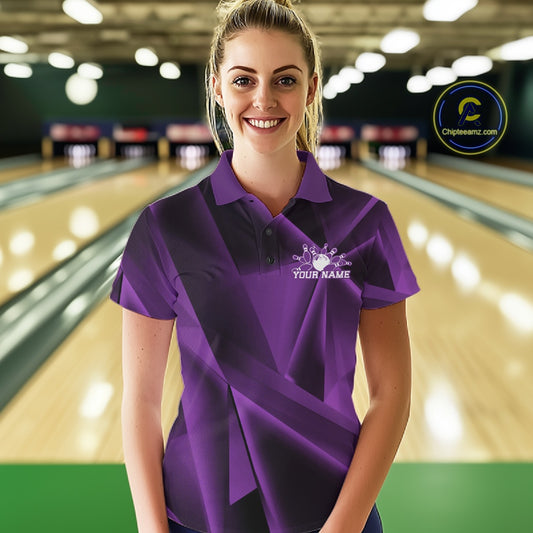 Woman wearing a purple bowling shirt with a logo in a bowling alley