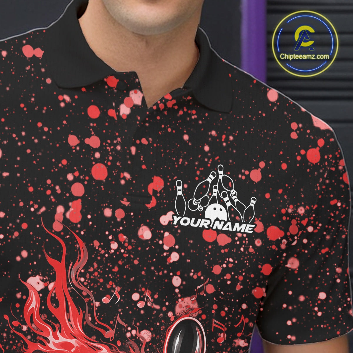 Close-up left chest detail of a black bowling polo shirt featuring flaming bowling graphics with red paint splashes.
