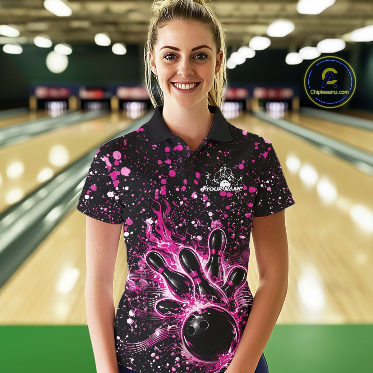 Female model wearing a black bowling polo shirt at the lane with pink music-themed paint splatters and bowling graphics.
