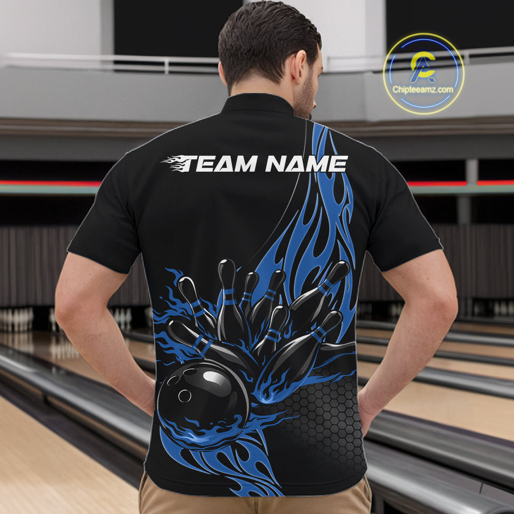 At the bowling lane, front view male model wearing black quarter zip shirt featuring blue flame bowling ball striking pins in energetic sports design.