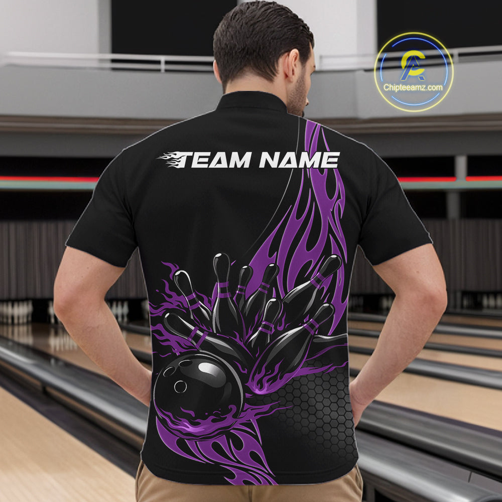 Front view of male model at bowling lane wearing black quarter zip shirt with purple flame bowling ball hitting pins in bold athletic motion artwork.