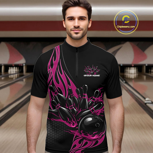Male model front view in bowling lane wearing black quarter zip shirt with pink flaming bowling ball striking pins in vibrant athletic design.