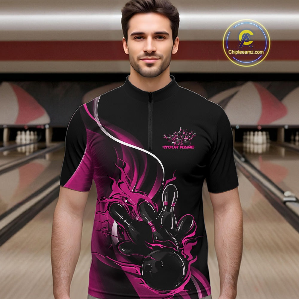 Male model front view in bowling alley wearing black and pink quarter zip shirt featuring flame bowling strike themed graphics