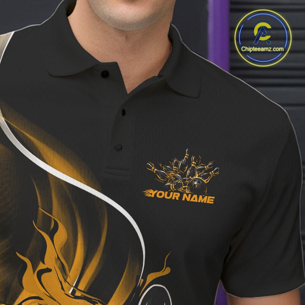 Close-up view of the left chest area of a black and yellow bowling polo shirt showing a flame bowling ball and pins design detail.