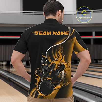 Male model front view inside bowling center wearing black and yellow quarter zip shirt featuring flaming bowling ball hitting pins artwork