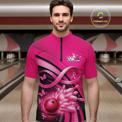 Male model in a bowling alley wearing a pink quarter zip shirt with breast cancer awareness ribbons, butterflies, and bowling graphics.