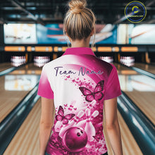 Load image into Gallery viewer, Back view of a female model wearing a pink bowling quarter zip with butterfly artwork and bowling graphics at the bowling lane