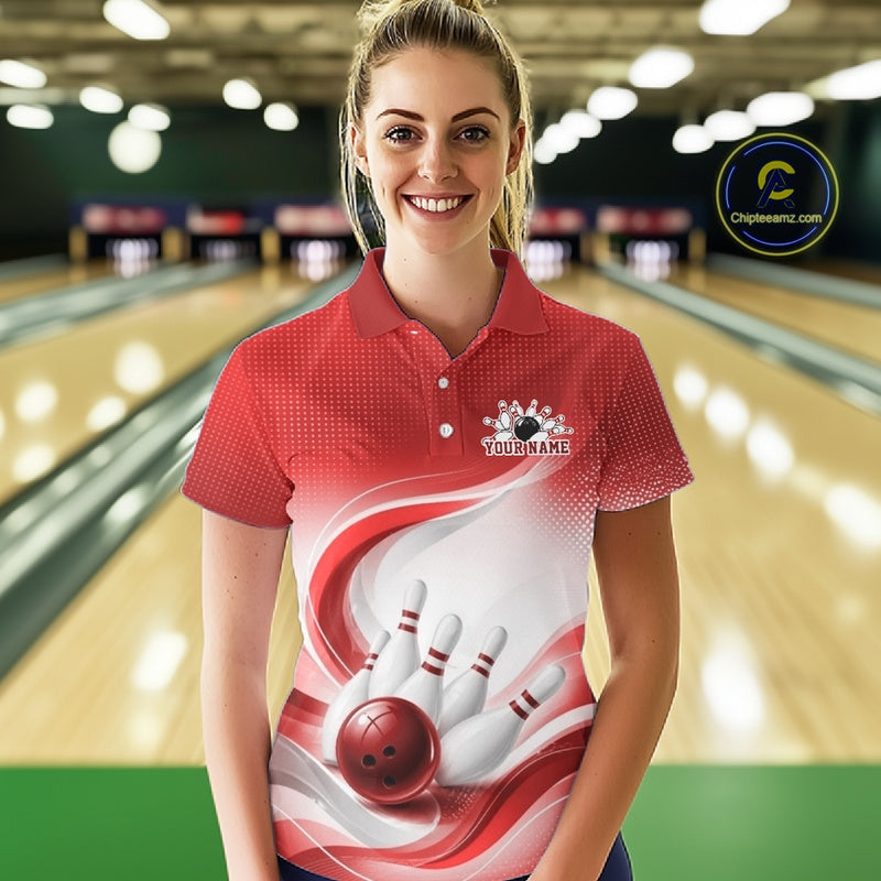 Female model wearing a white and red bowling polo shirt with graceful wave patterns and a bowling strike graphic inside a bowling center