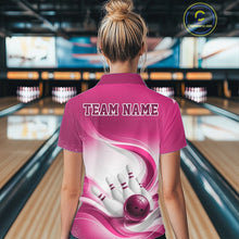 Load image into Gallery viewer, Womens white and pink bowling polo shirt shown from the back with dynamic wave graphics and a bowling strike design in a bowling alley