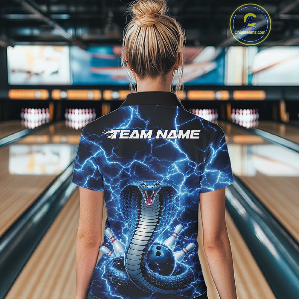 Back view of a womens bowling polo displaying a blue cobra around a bowling ball with lightning accents.
