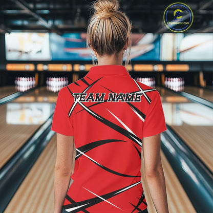 Back view of a female bowler wearing a red, black, and white bowling polo shirt in a bowling lane