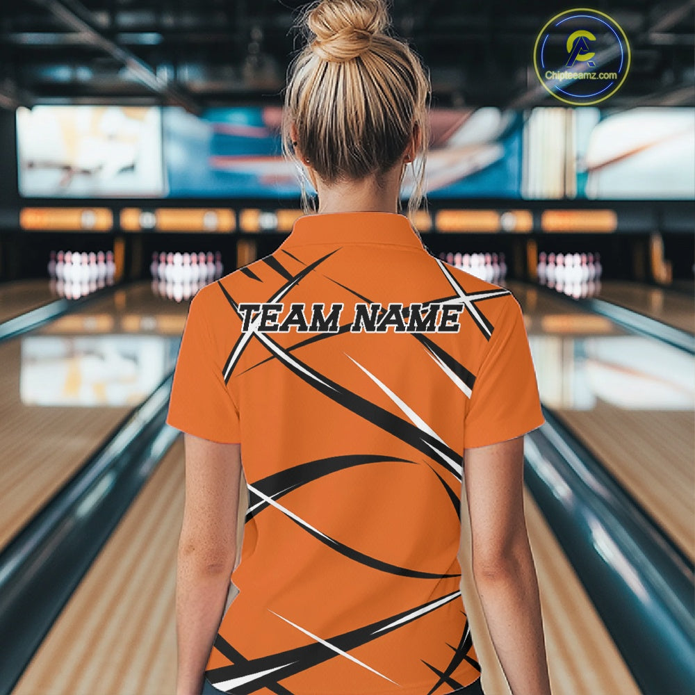 Back view of a female model wearing an orange, black, and white bowling polo shirt in a bowling lane